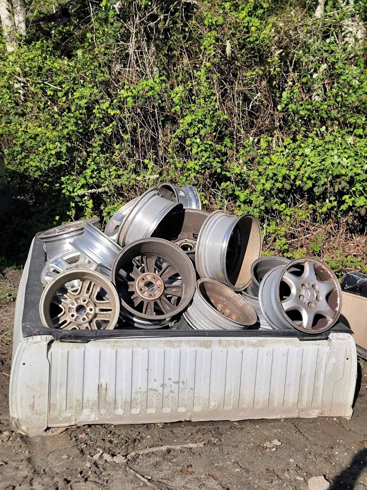A pile of aluminum wheels is sitting on top of a truck bed — Poulsbo, WA — Yank-A-Part