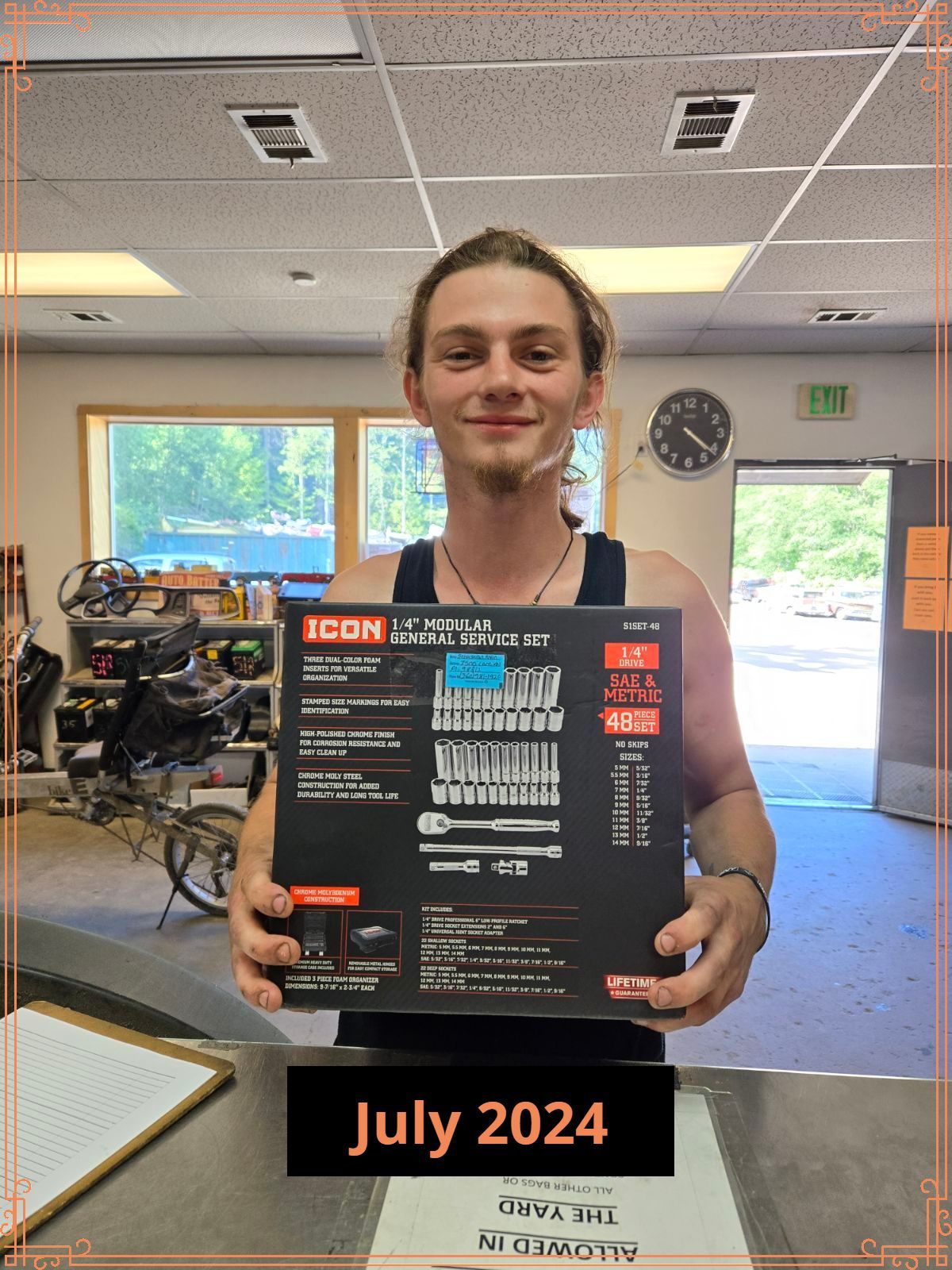 Man smiling, holding tool set in a store, “July 2024” text.