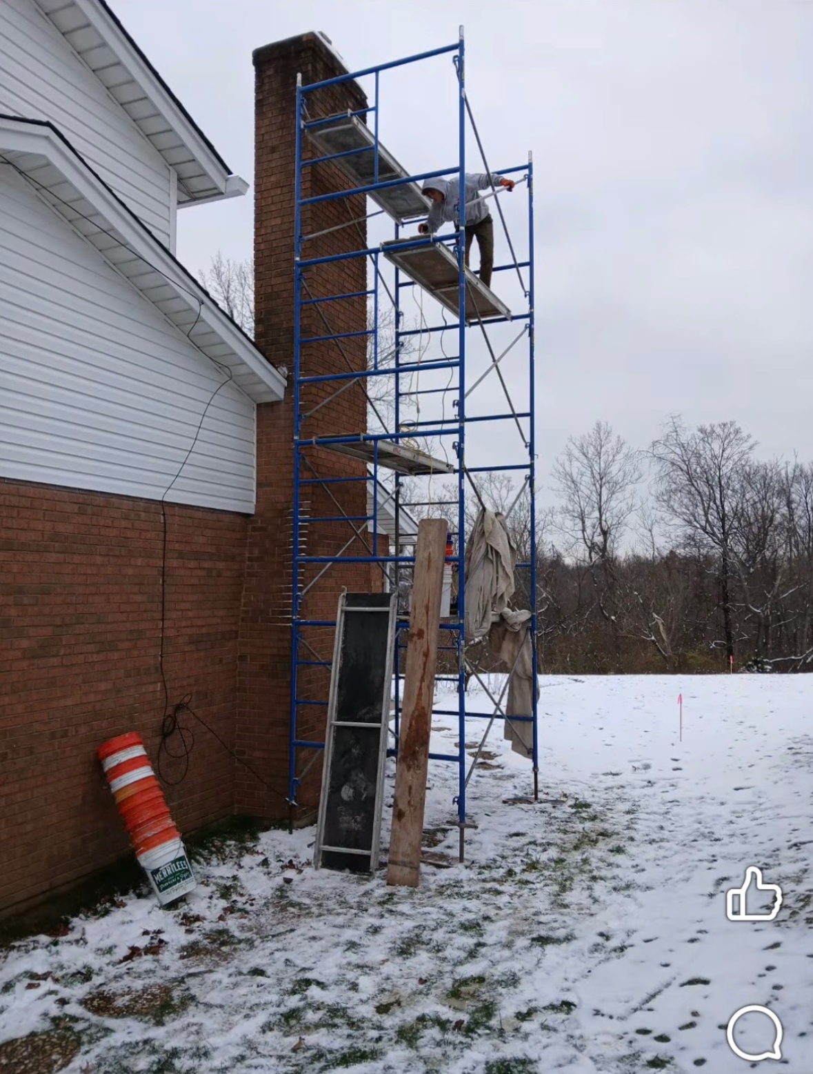 Chimney masonry repair in progress with scaffolding on Cincinnati residential home