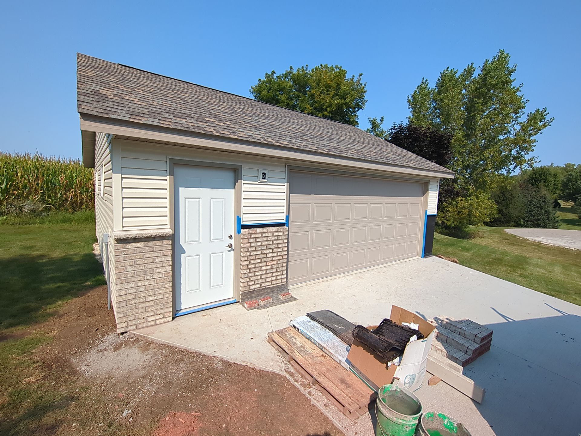 A garage with a white door and a gray roof