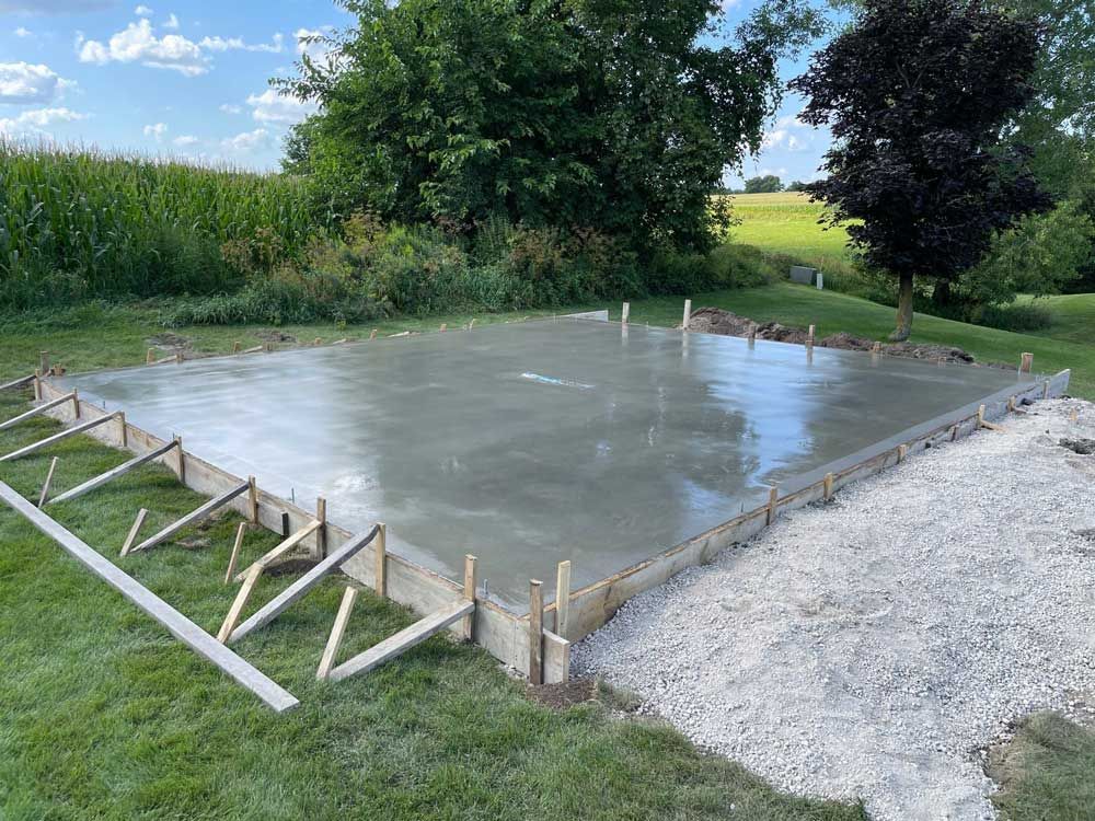 A large concrete slab is sitting on top of a lush green field.