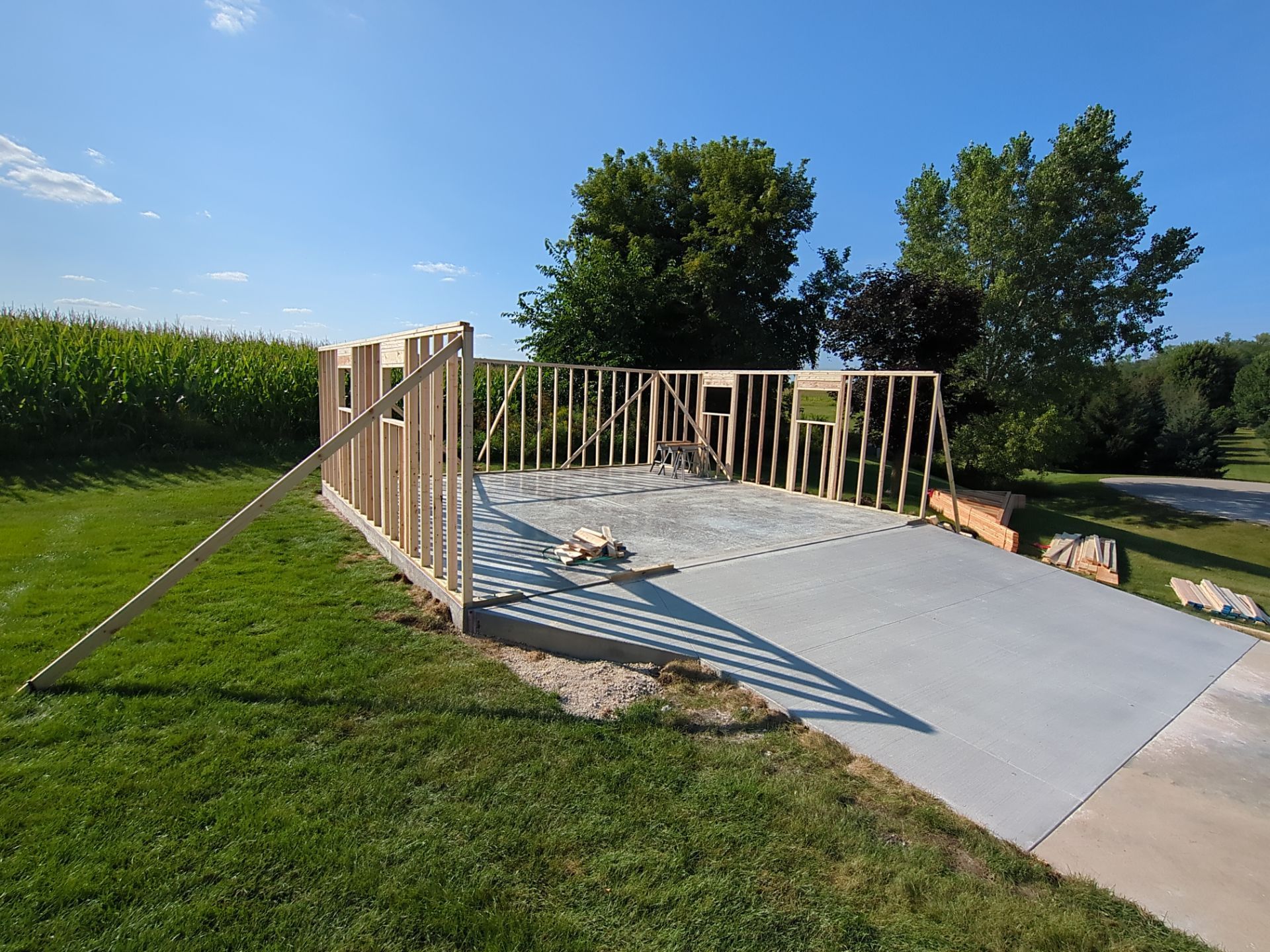 A concrete driveway with a wooden fence surrounding it