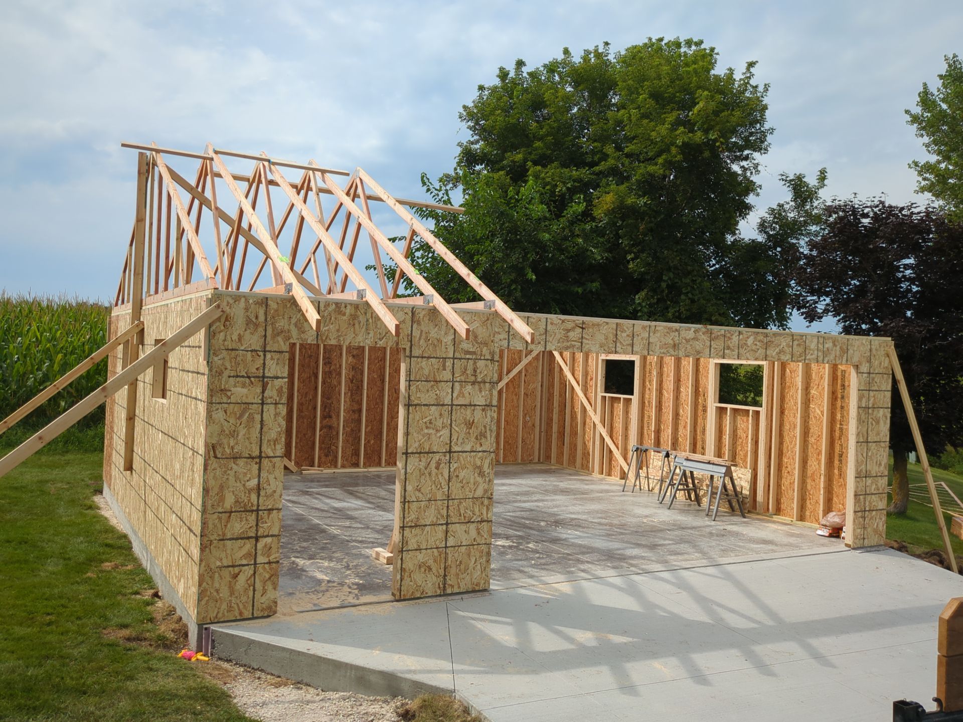 A wooden structure is being built in a backyard