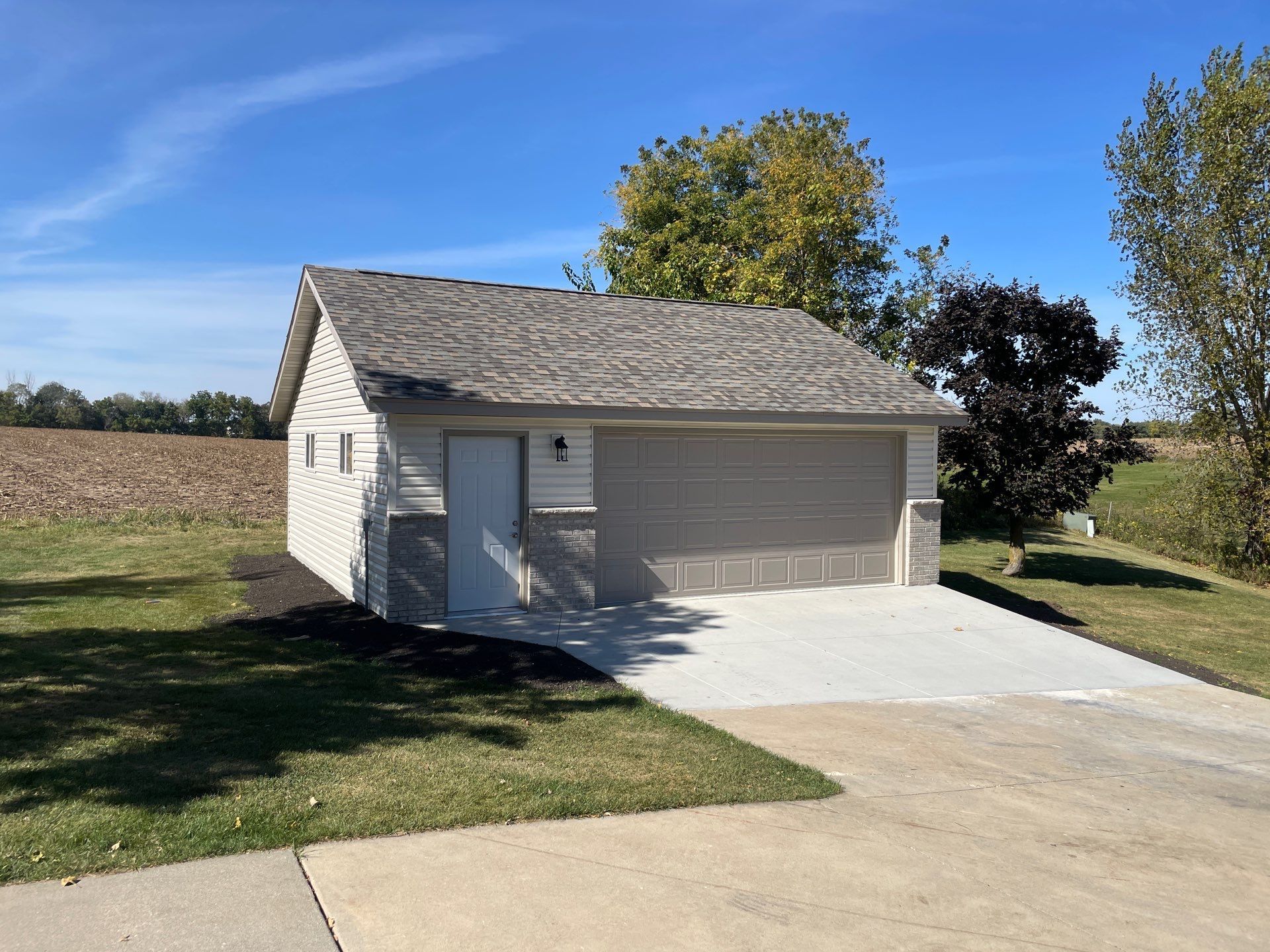 A garage with a white door and a gray roof