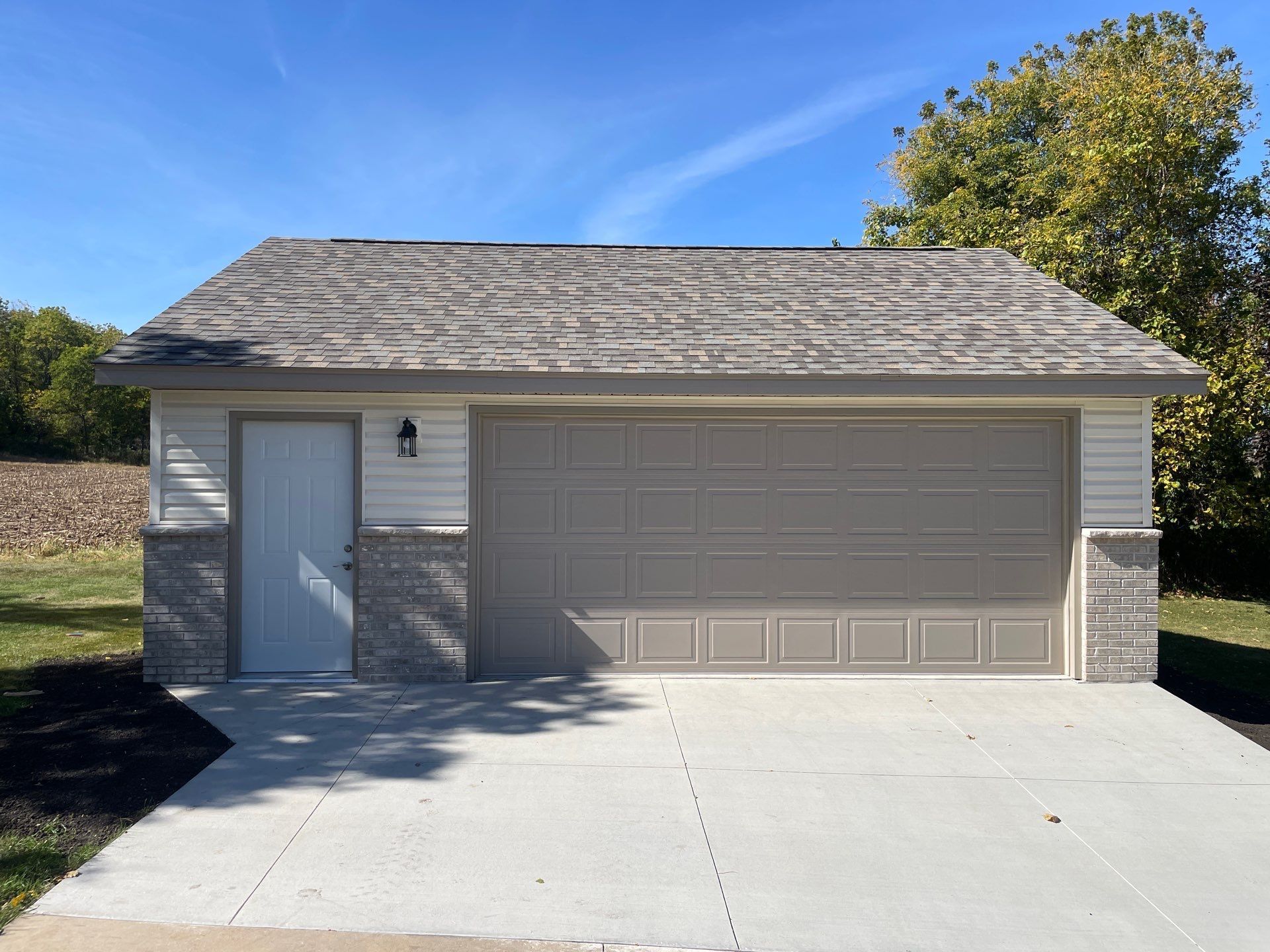 A garage with a white door and a gray roof