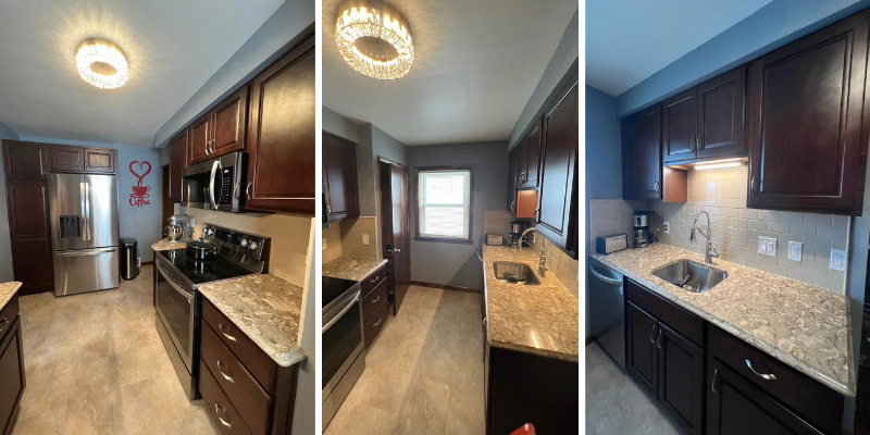 A kitchen with dark wood cabinets, granite countertops, stainless steel appliances, and a light-colored floor.