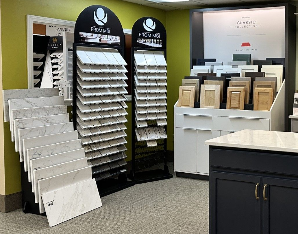 Displays of tile and cabinet samples in a showroom. Various colors and textures are visible.