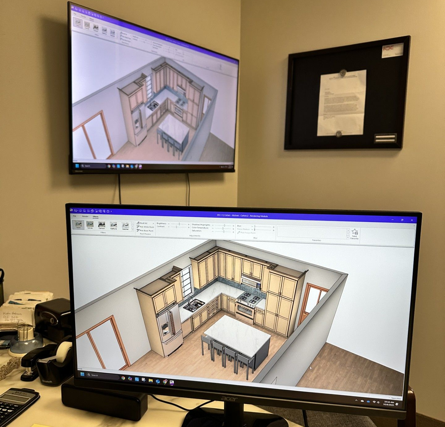 Two monitors displaying a kitchen design rendering in a corner office setting. One is mounted above the other.