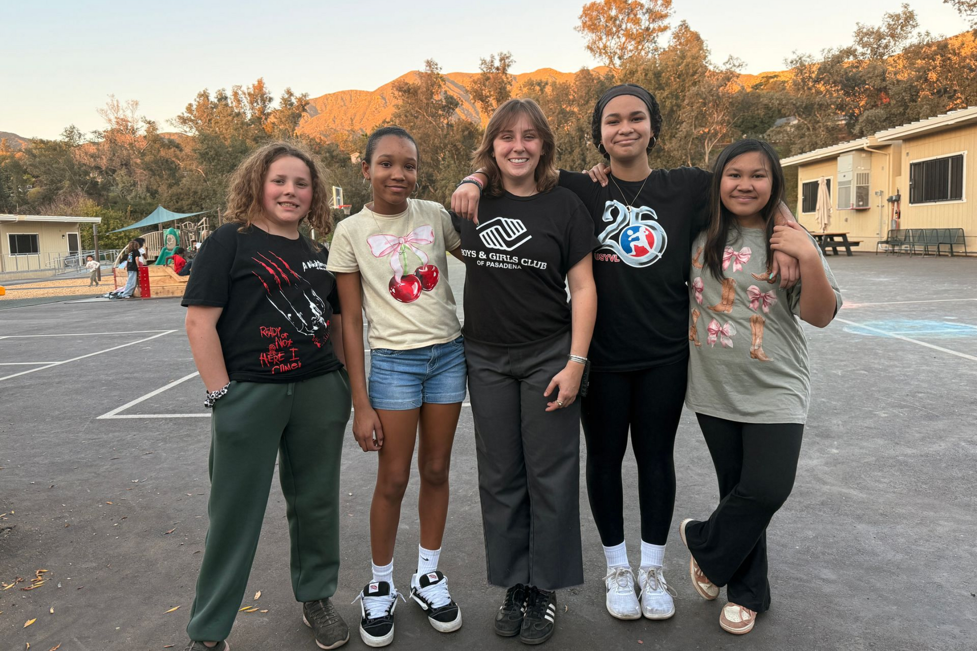 counselor and 3 children playing foosball