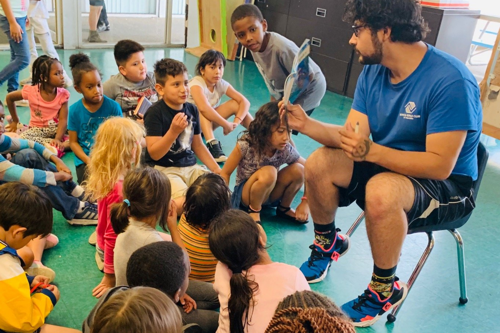 Counselor with girl child learning to swim