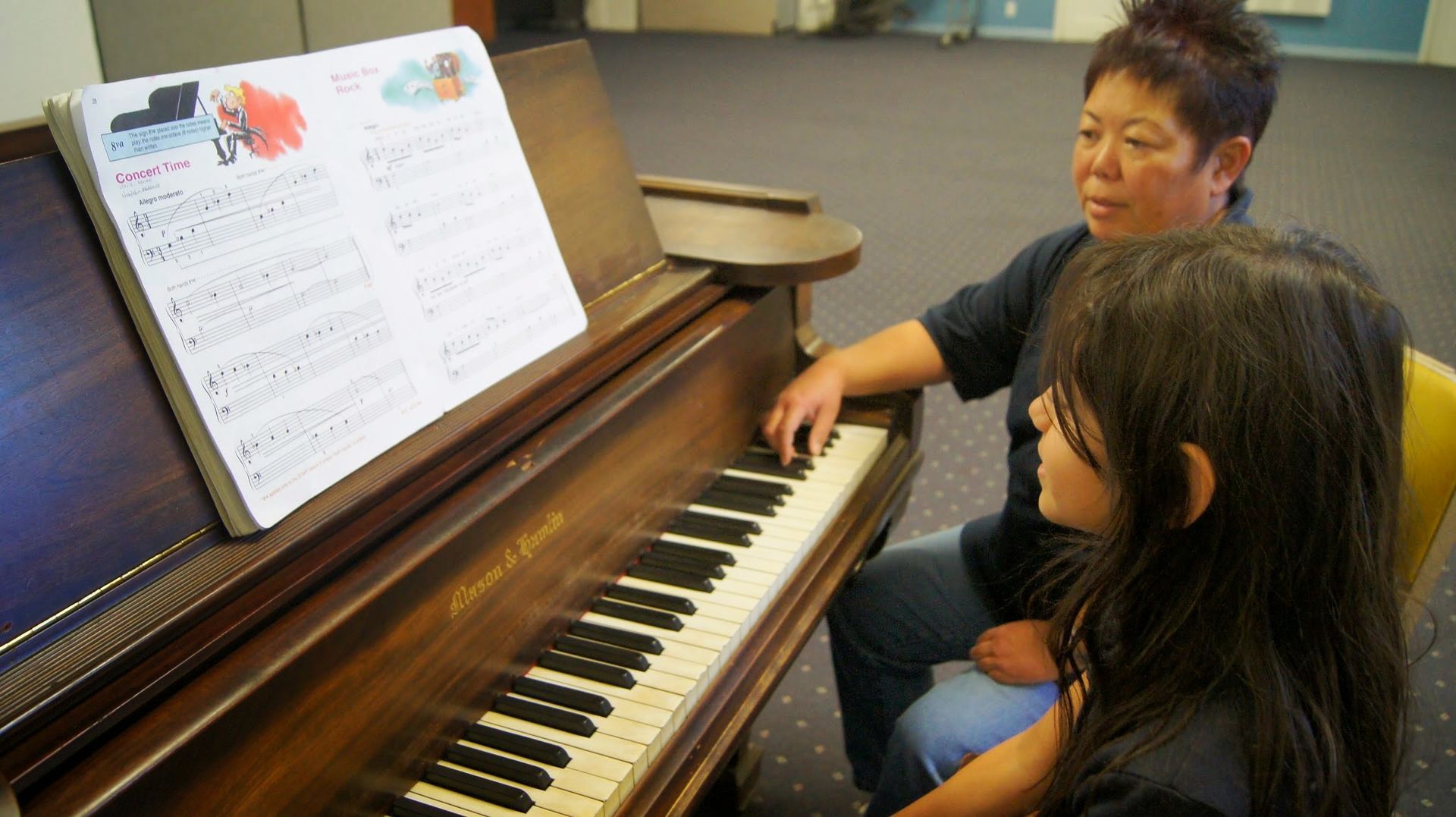 counselor and 3 children playing foosball
