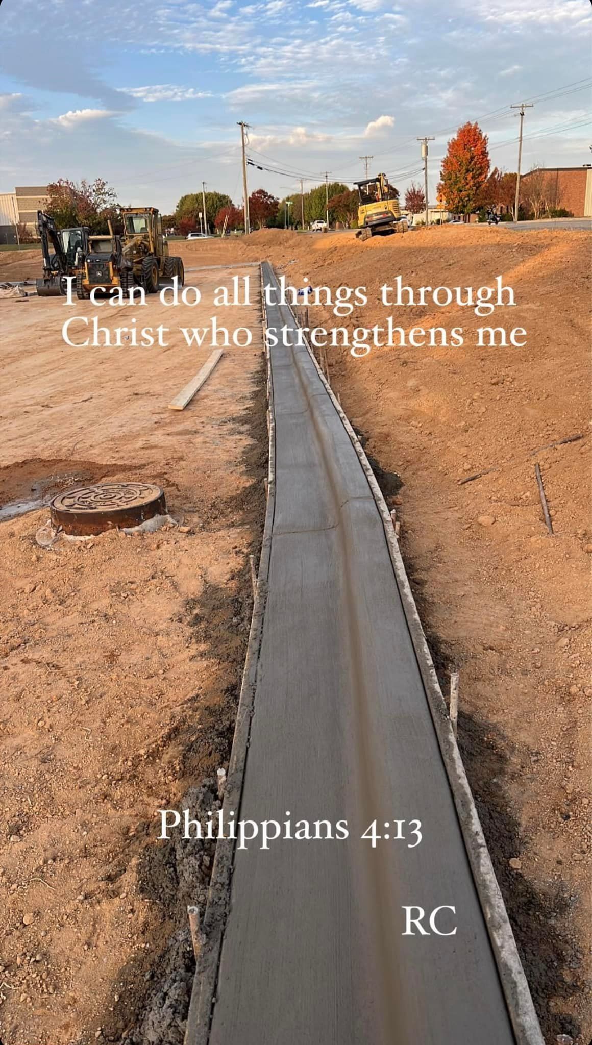 Construction site with a newly poured concrete curb; Bible verse 