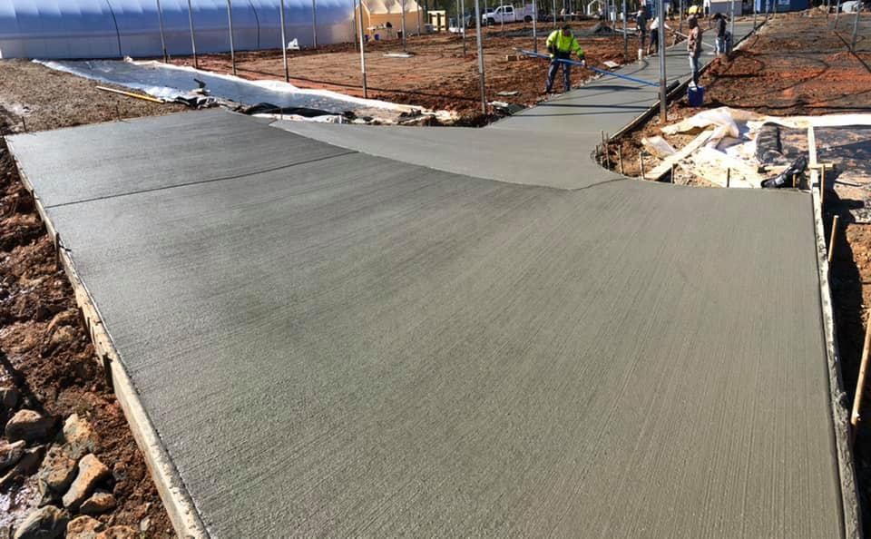 Newly poured concrete sidewalk under construction, outdoors.
