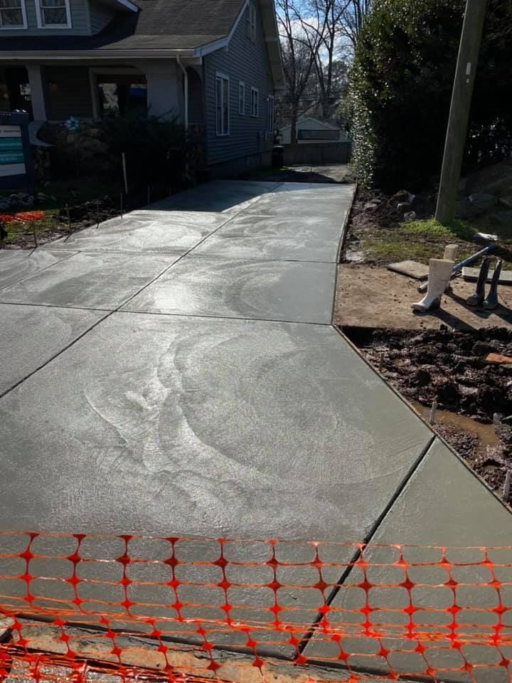 Freshly poured concrete driveway with safety fencing.