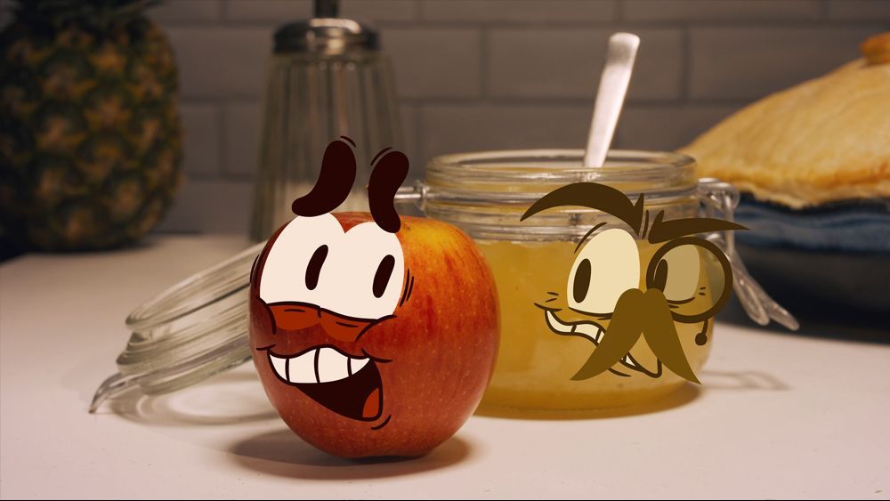 An animated apple smiles next to a jar of jam, and a jam-animated character with a mustache.