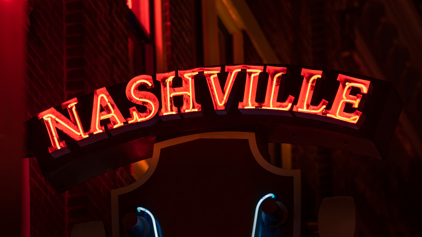 A neon sign for nashville is lit up at night.