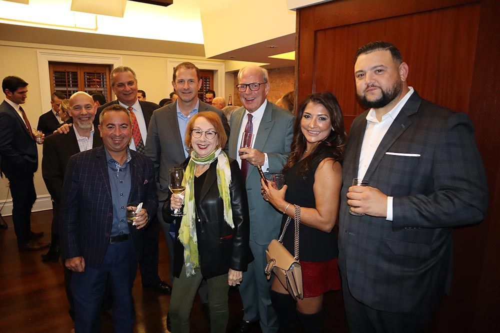 A group of people are posing for a picture in a room.