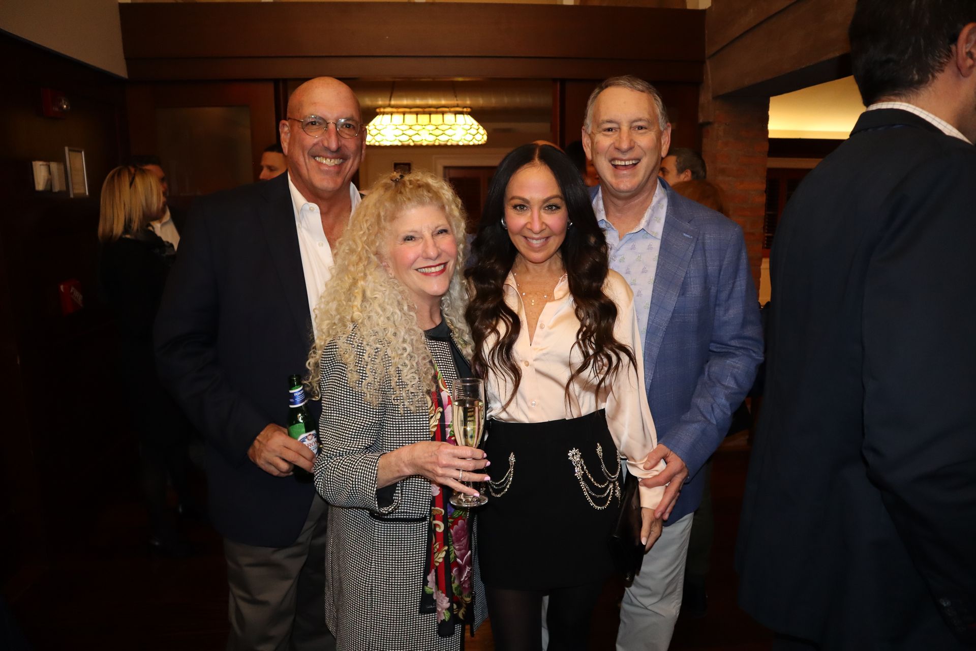 A group of people are posing for a picture in a room.