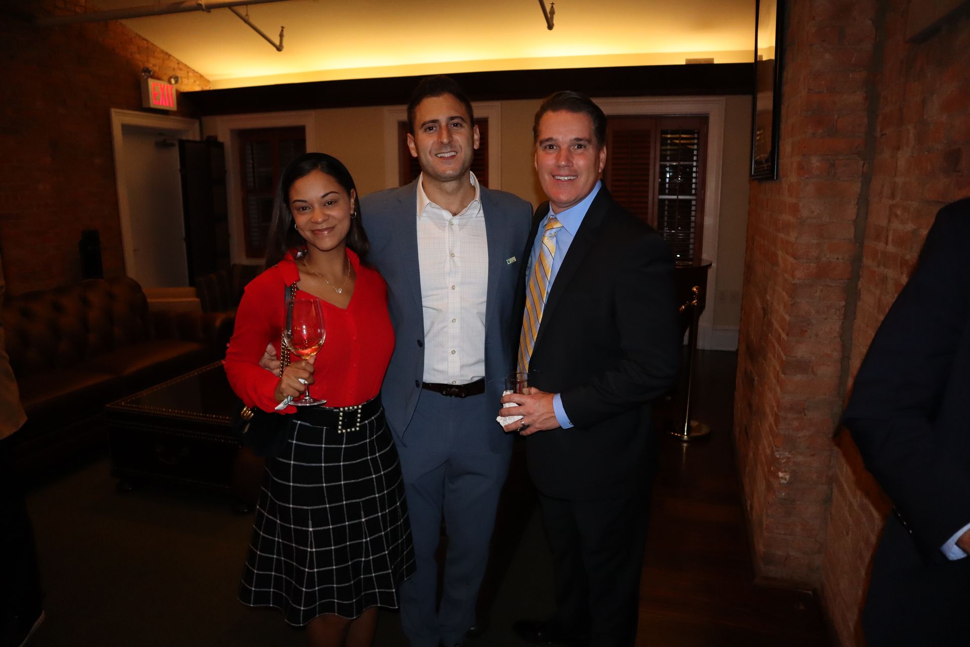 A group of people are posing for a picture in a room.