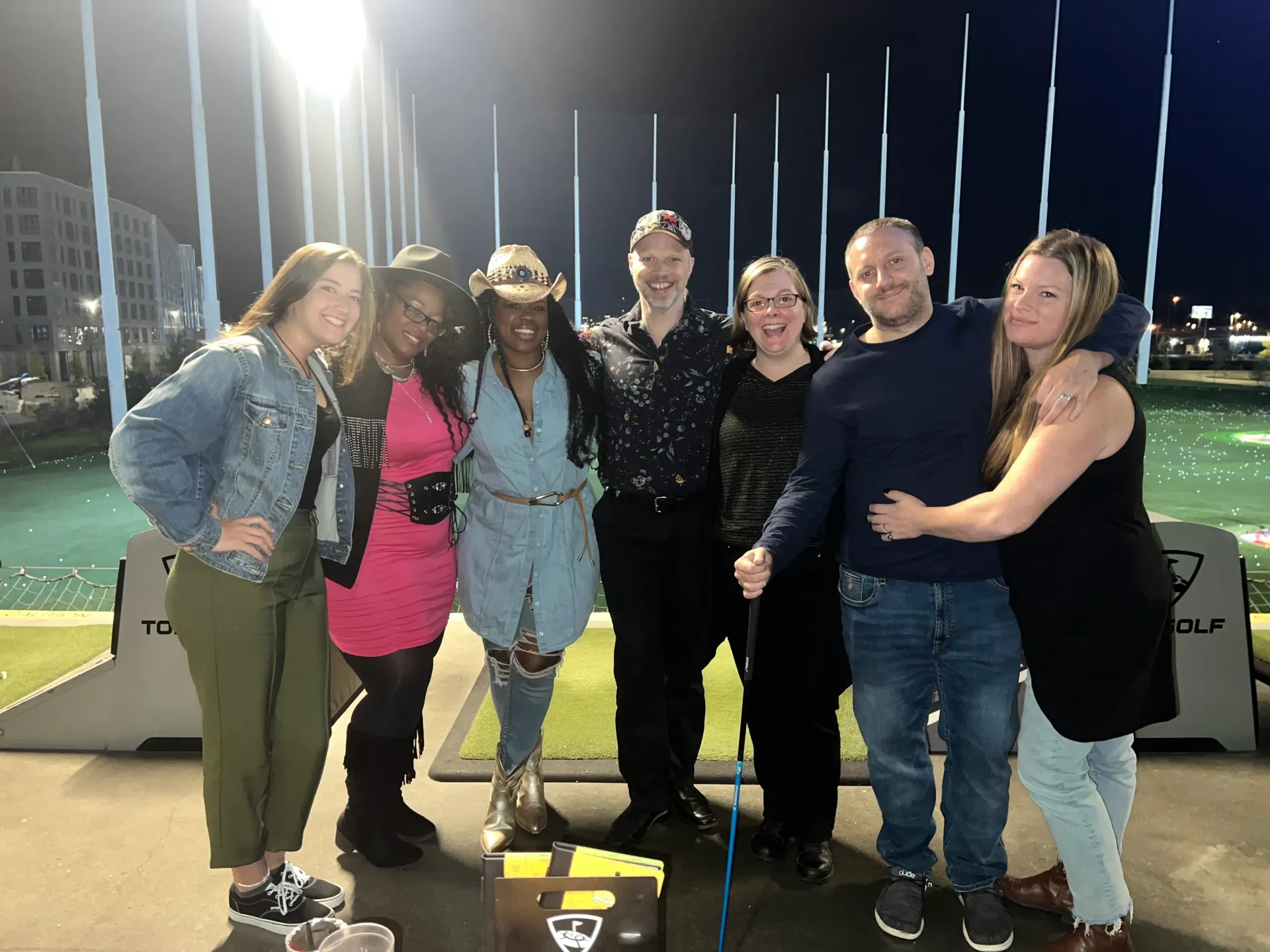 A group of people are posing for a picture on a golf course.