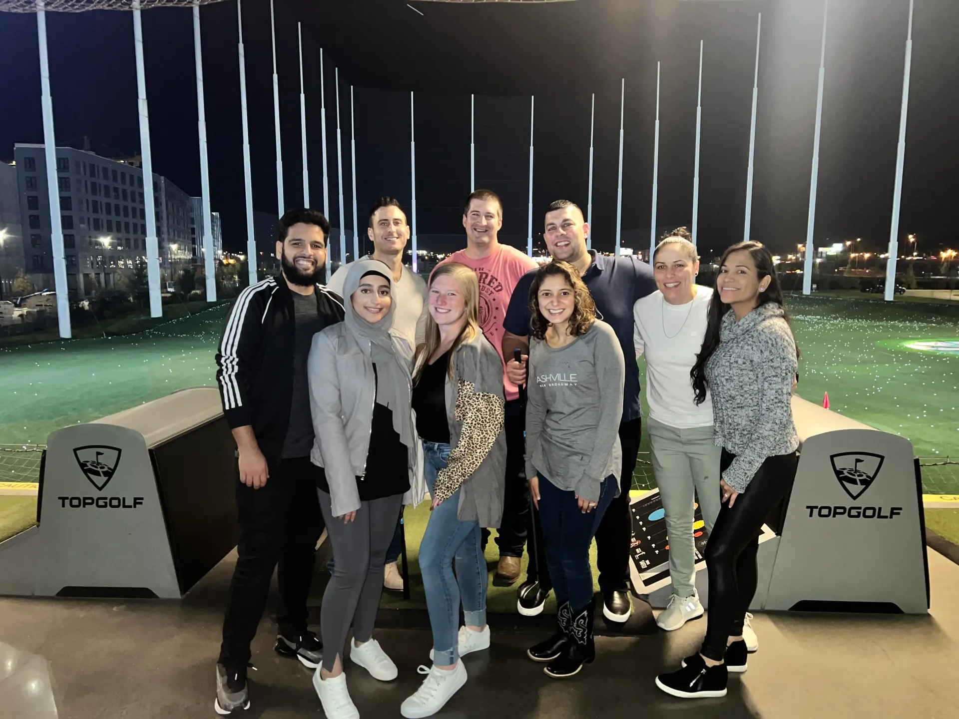 A group of people are posing for a picture at a golf course.