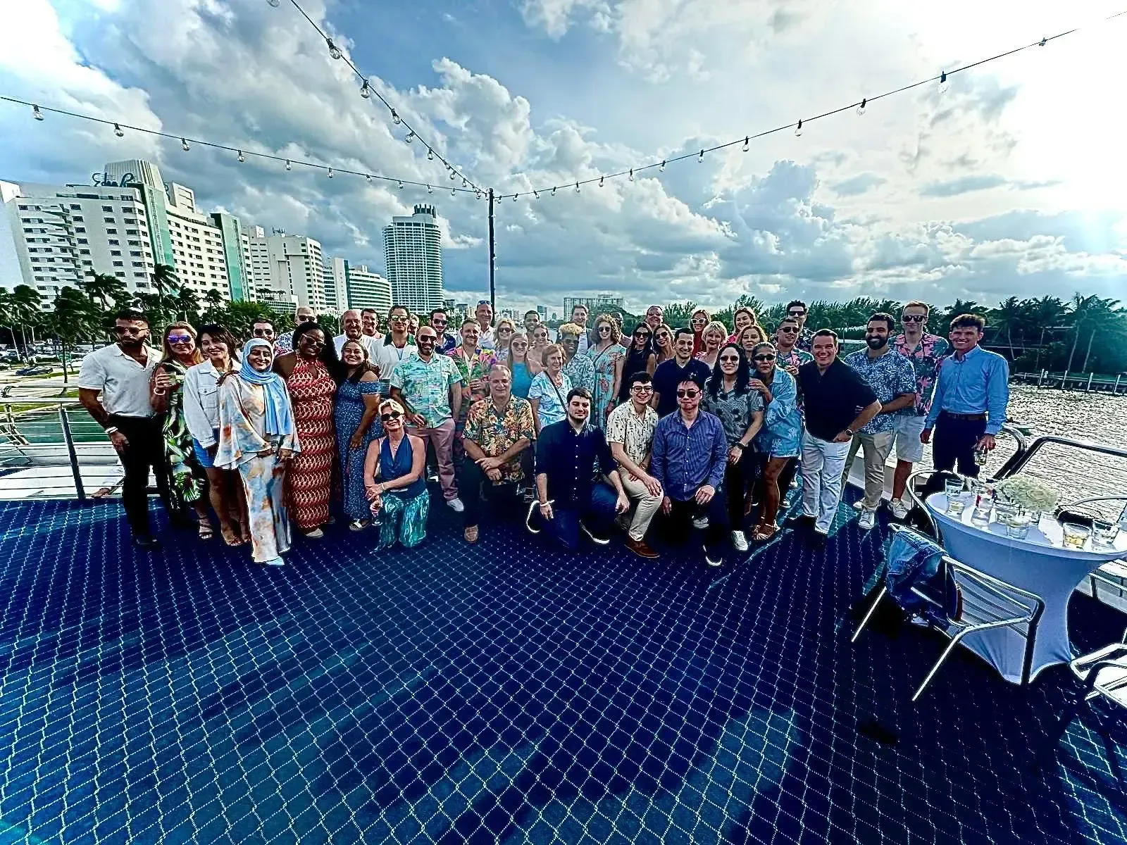A large group of people are posing for a picture on a boat.