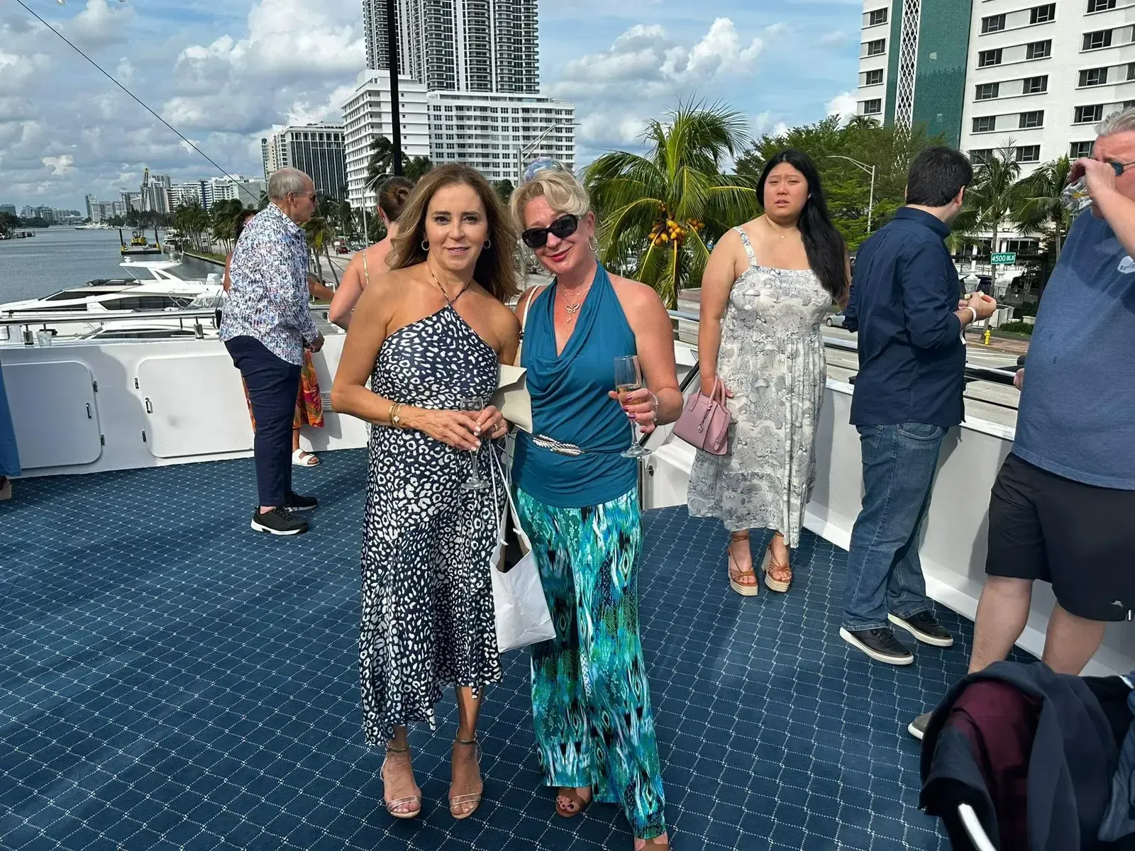 Two women are posing for a picture on a boat.