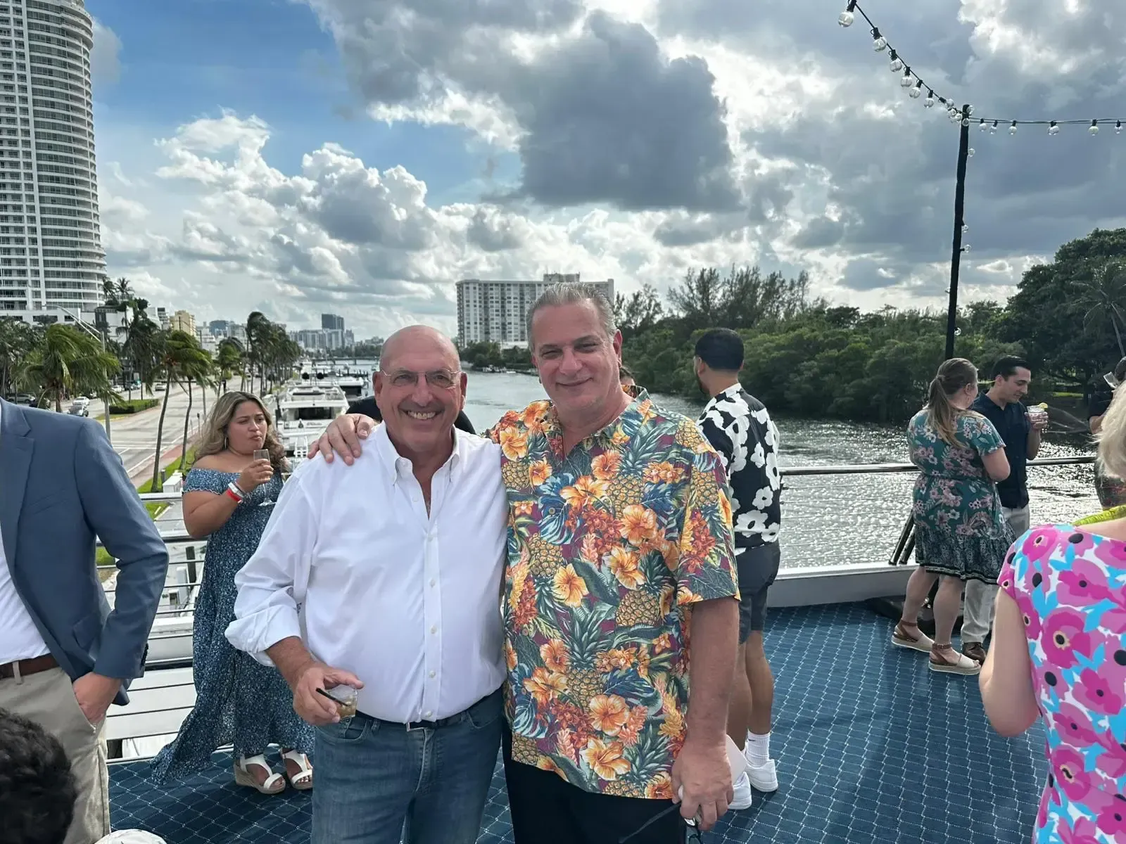 Two men are posing for a picture on a boat.