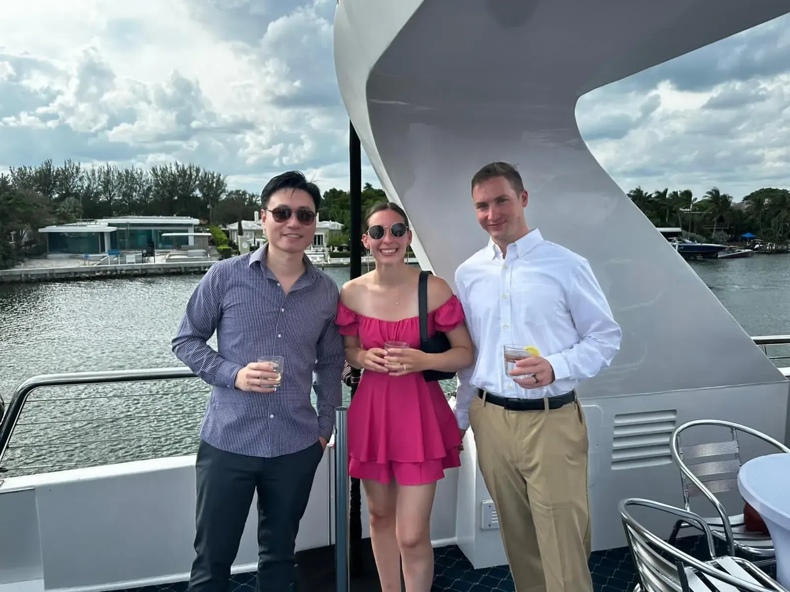 Three people are posing for a picture on a boat.