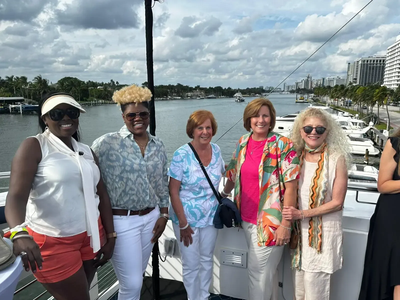 A group of women are posing for a picture on a boat.