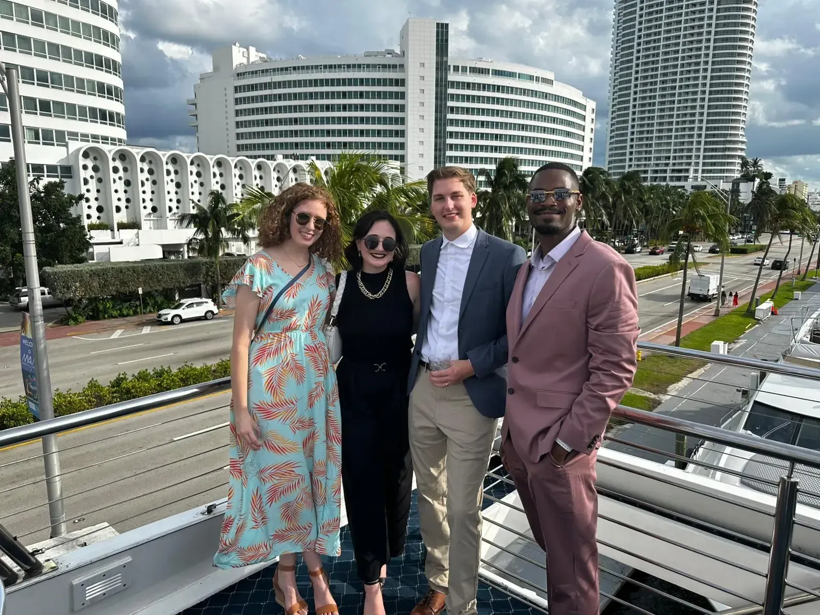 A group of people are posing for a picture on the deck of a boat.