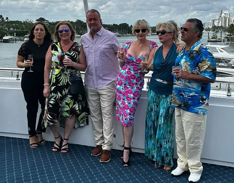 A group of people standing next to each other on a boat