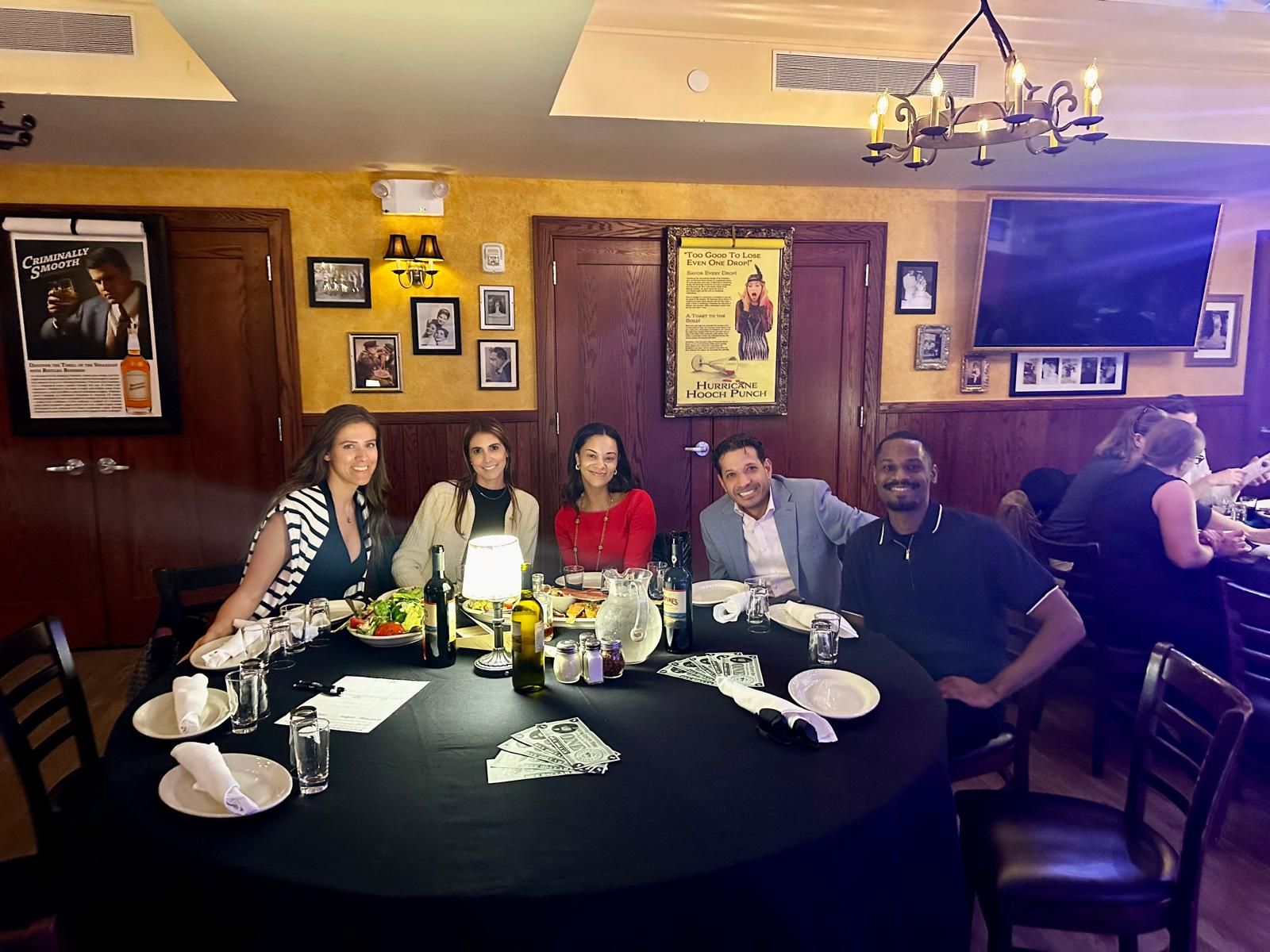 A group of people are sitting around a table in a restaurant.