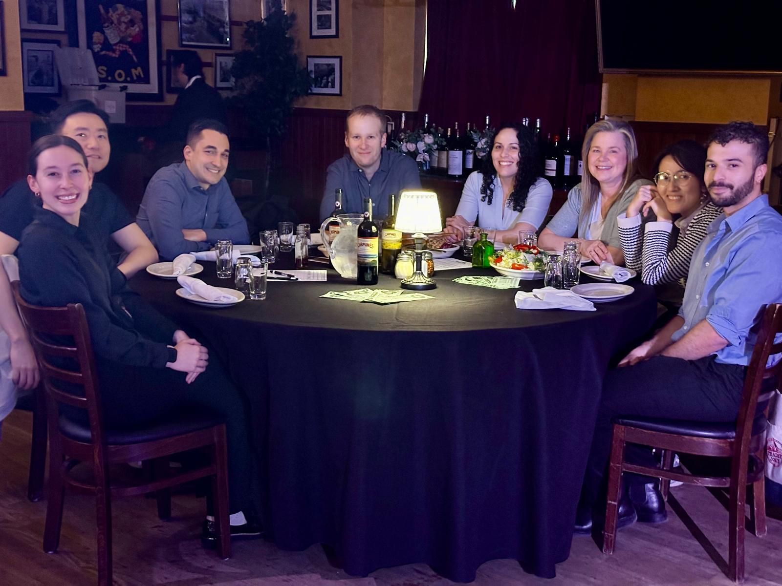 A group of people are sitting around a table in a restaurant.