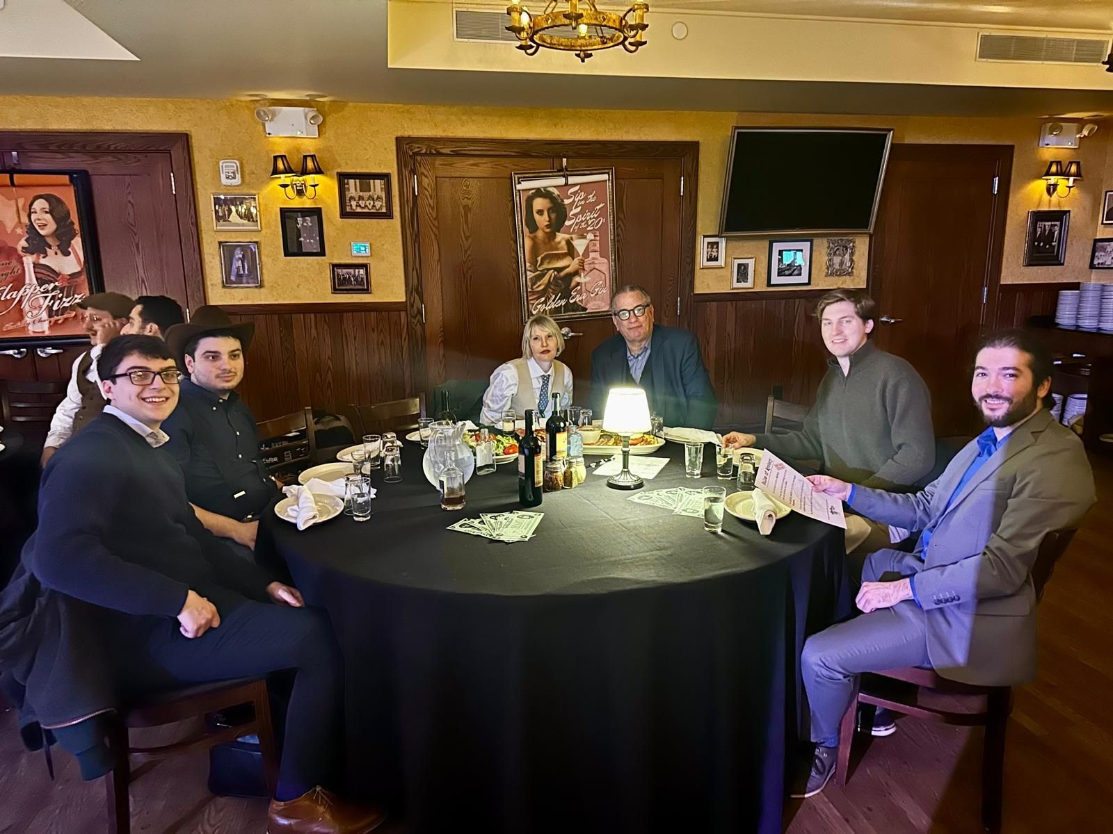 A group of people are sitting around a table in a restaurant.