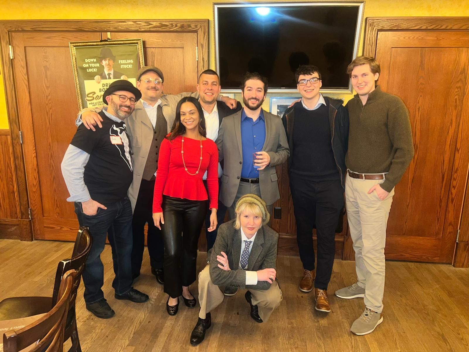 A group of people are posing for a picture in a room.