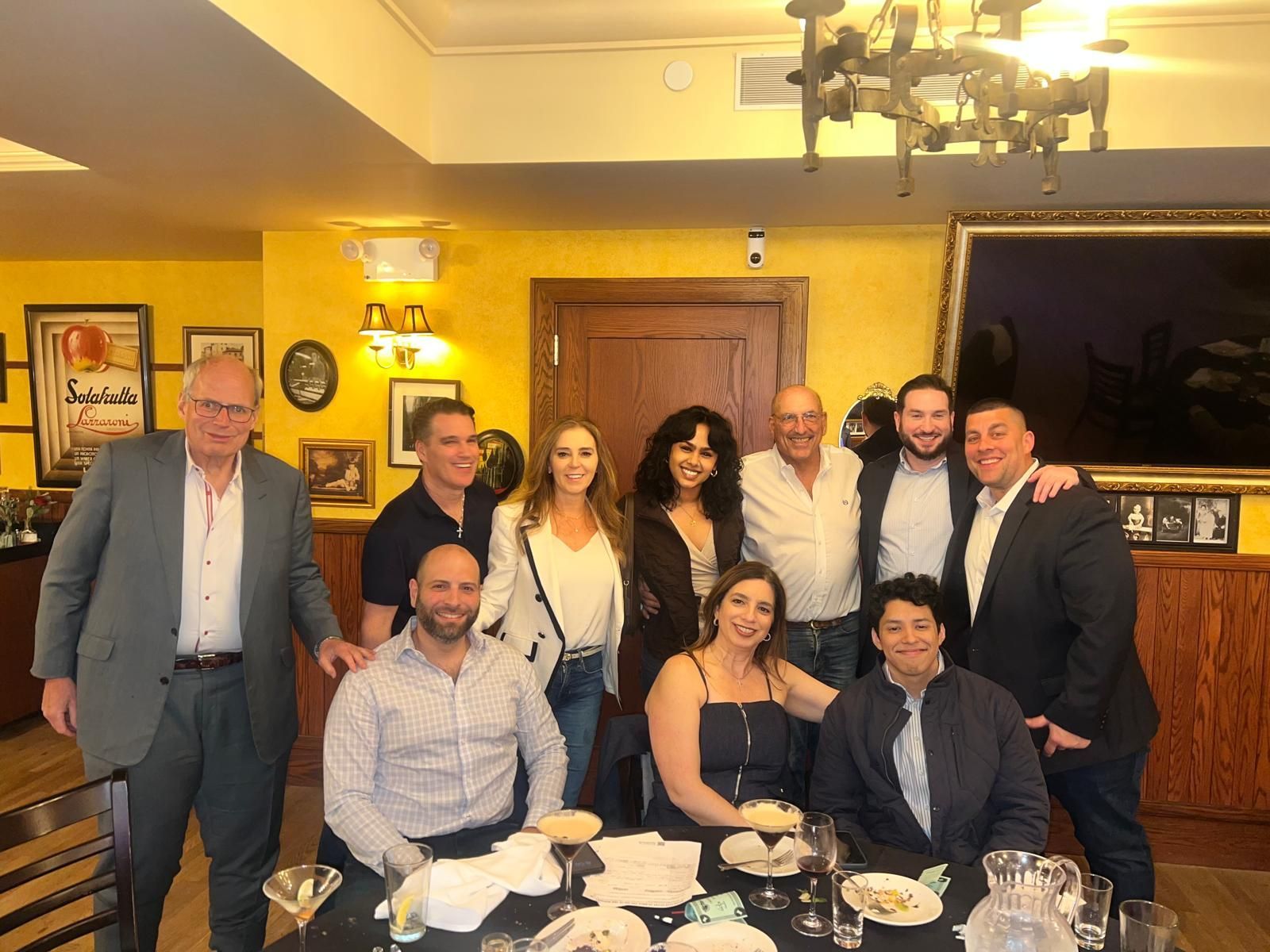 A group of people are posing for a picture in a restaurant.