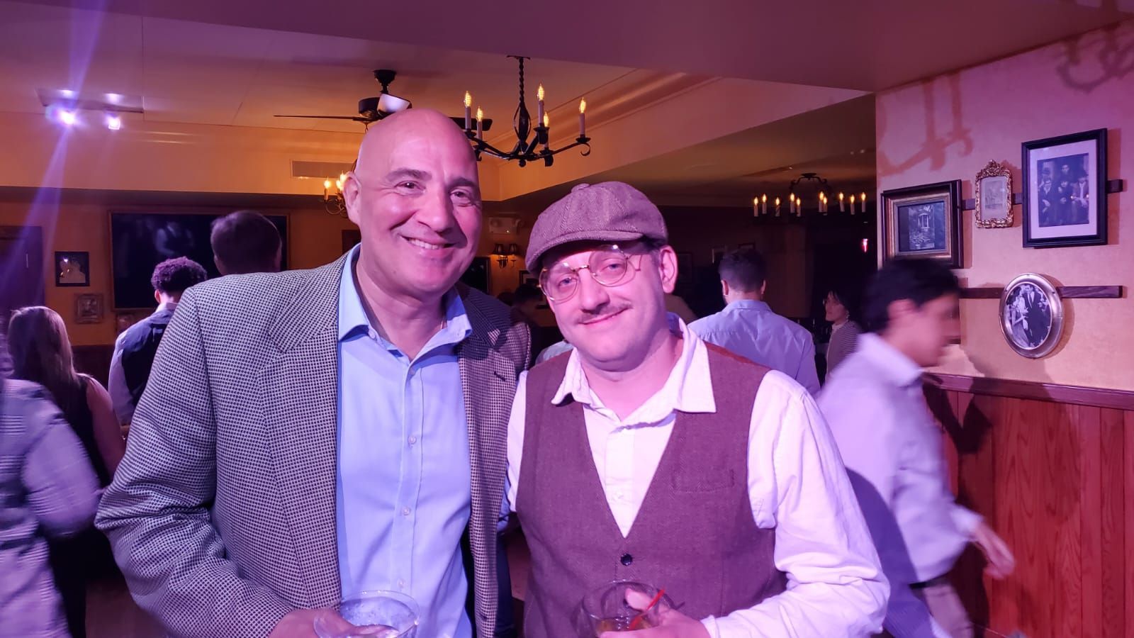 Two men are posing for a picture in a restaurant.