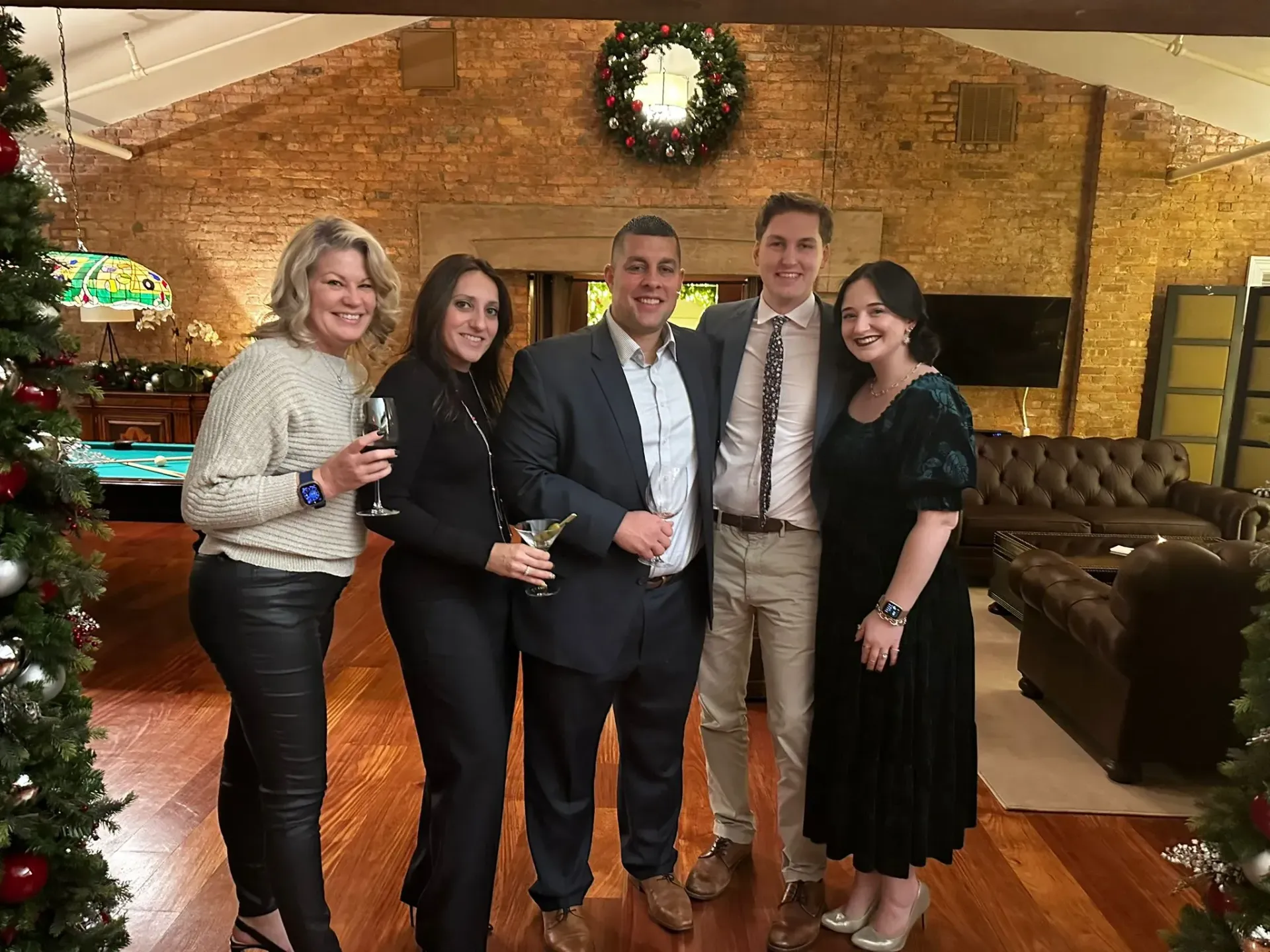 A group of people are posing for a picture in a living room.