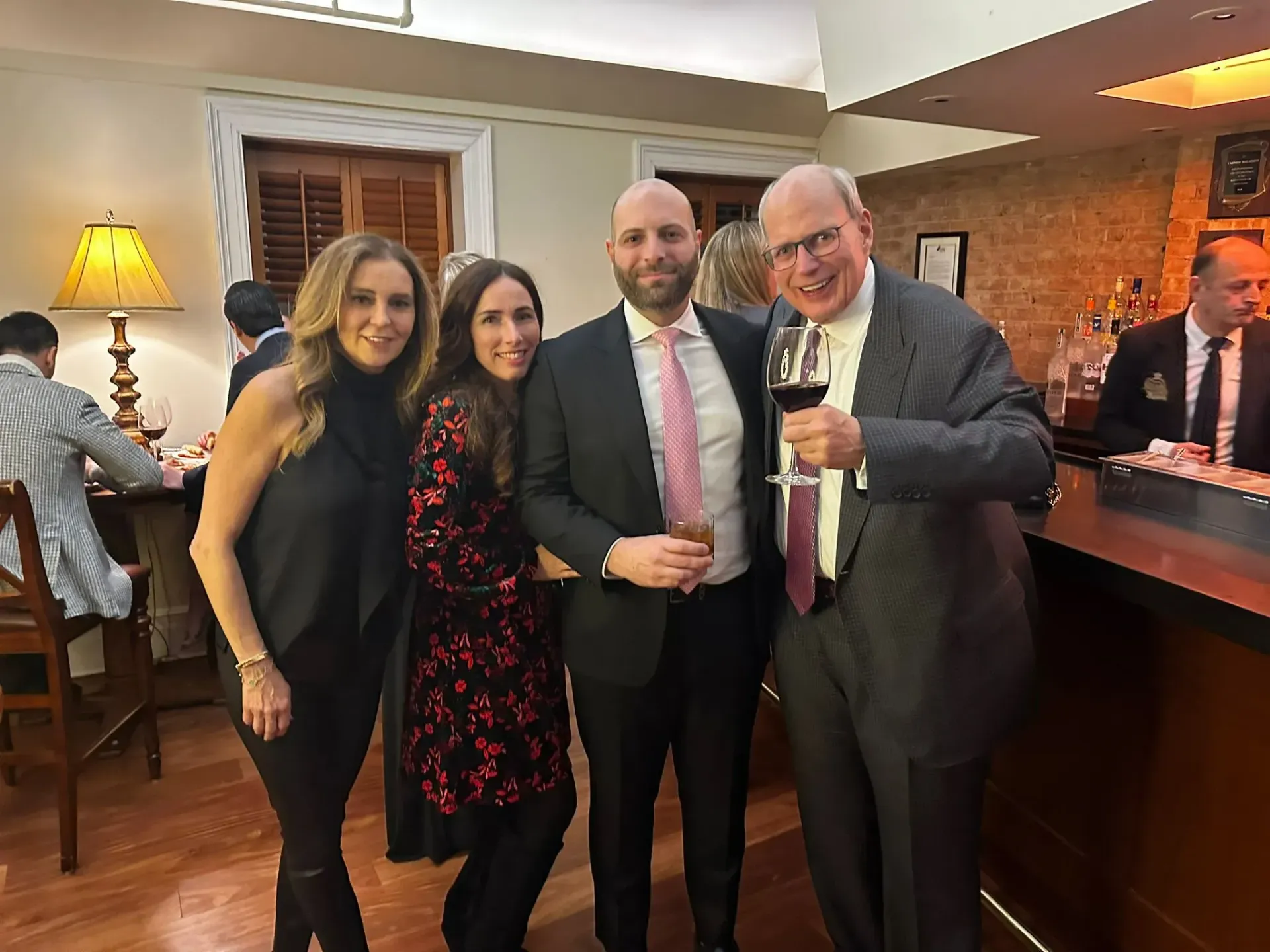 A group of people are posing for a picture in a restaurant.