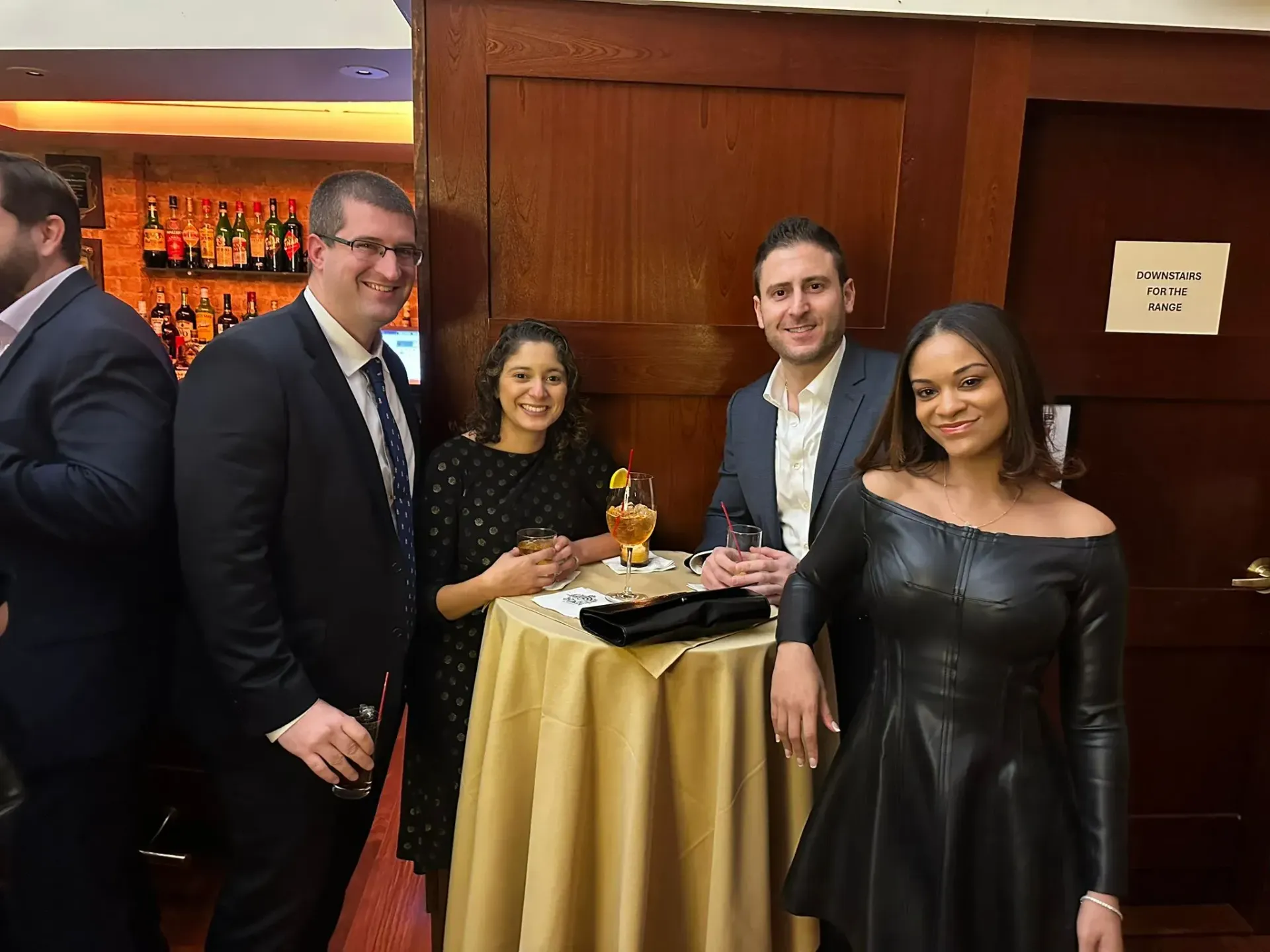 A group of people are standing around a table in a room.