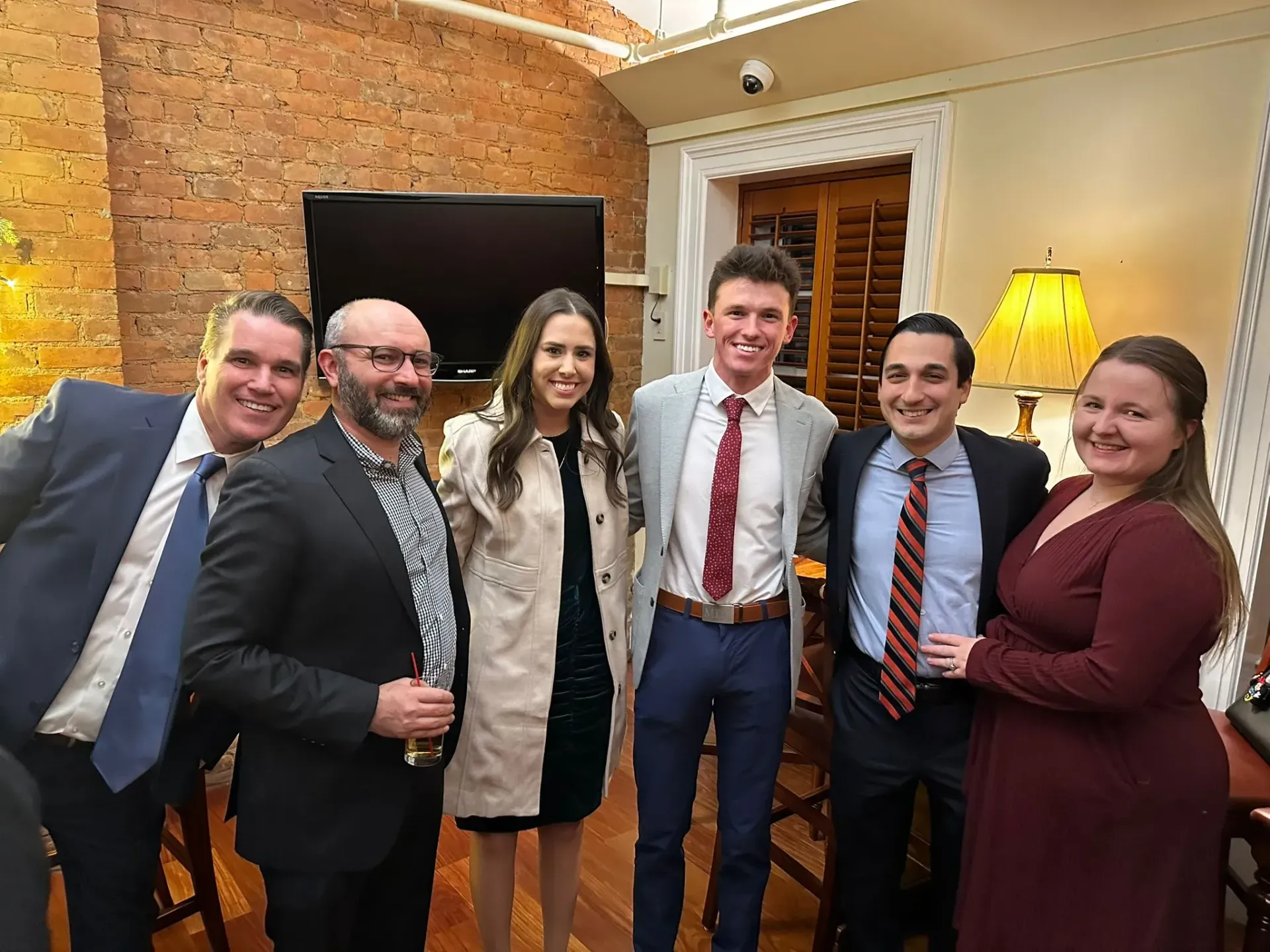 A group of people are posing for a picture in a room.