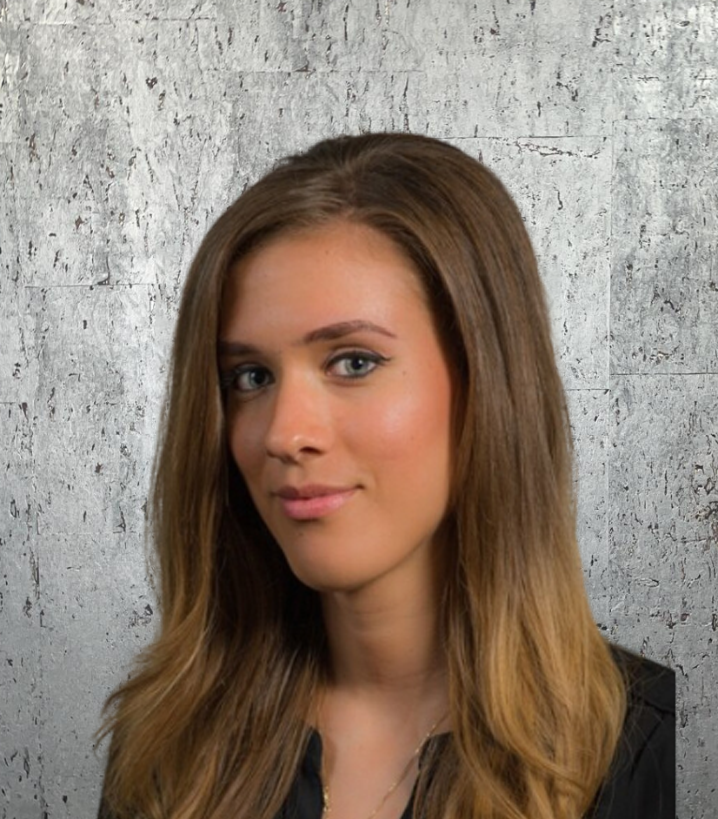 A woman with long brown hair is wearing a black shirt