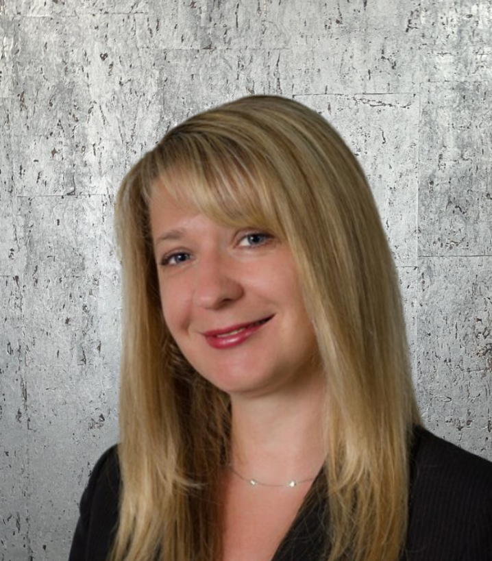 A woman with long blonde hair is wearing a black jacket