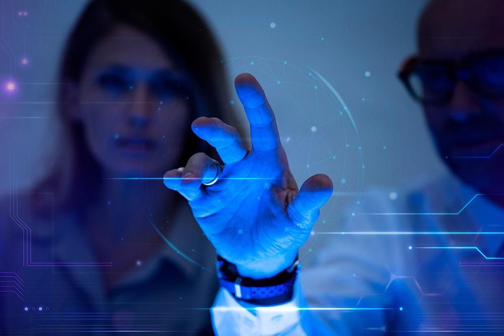 A man and a woman are looking at a futuristic screen.
