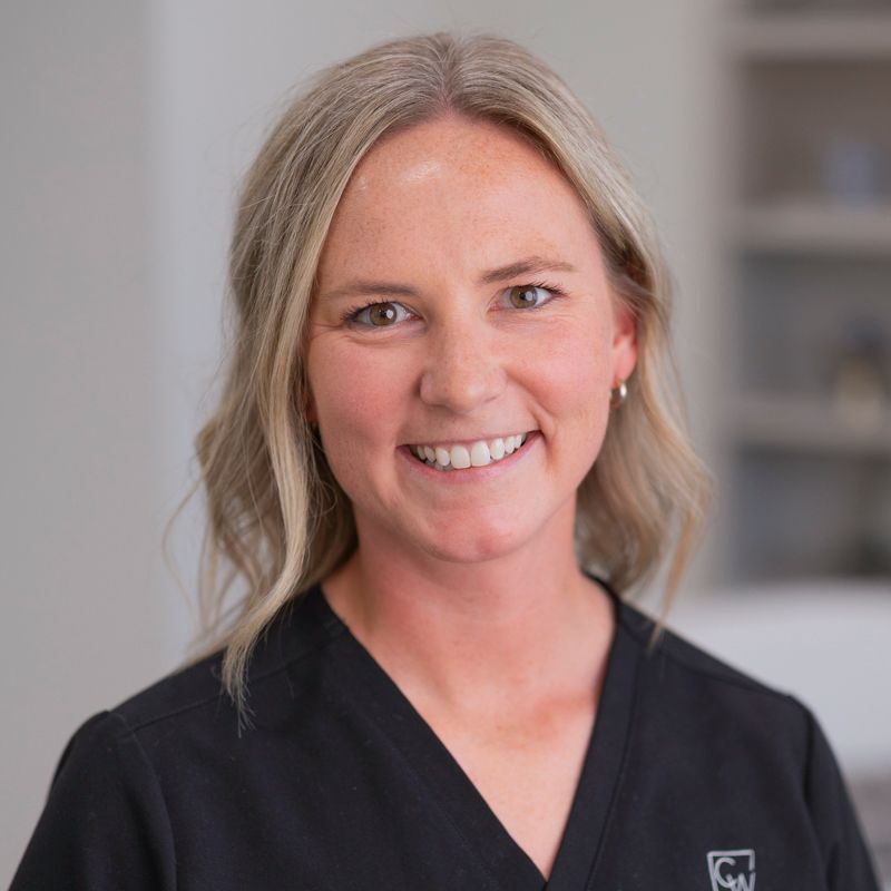 Image of four CWFPS staff members smiling at the camera at the Facial Plastic Surgery office in Leawood, KS.