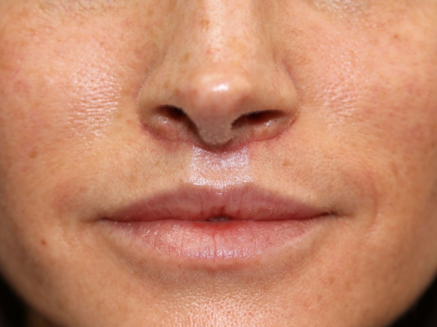 A close up of a woman 's lips and nose.