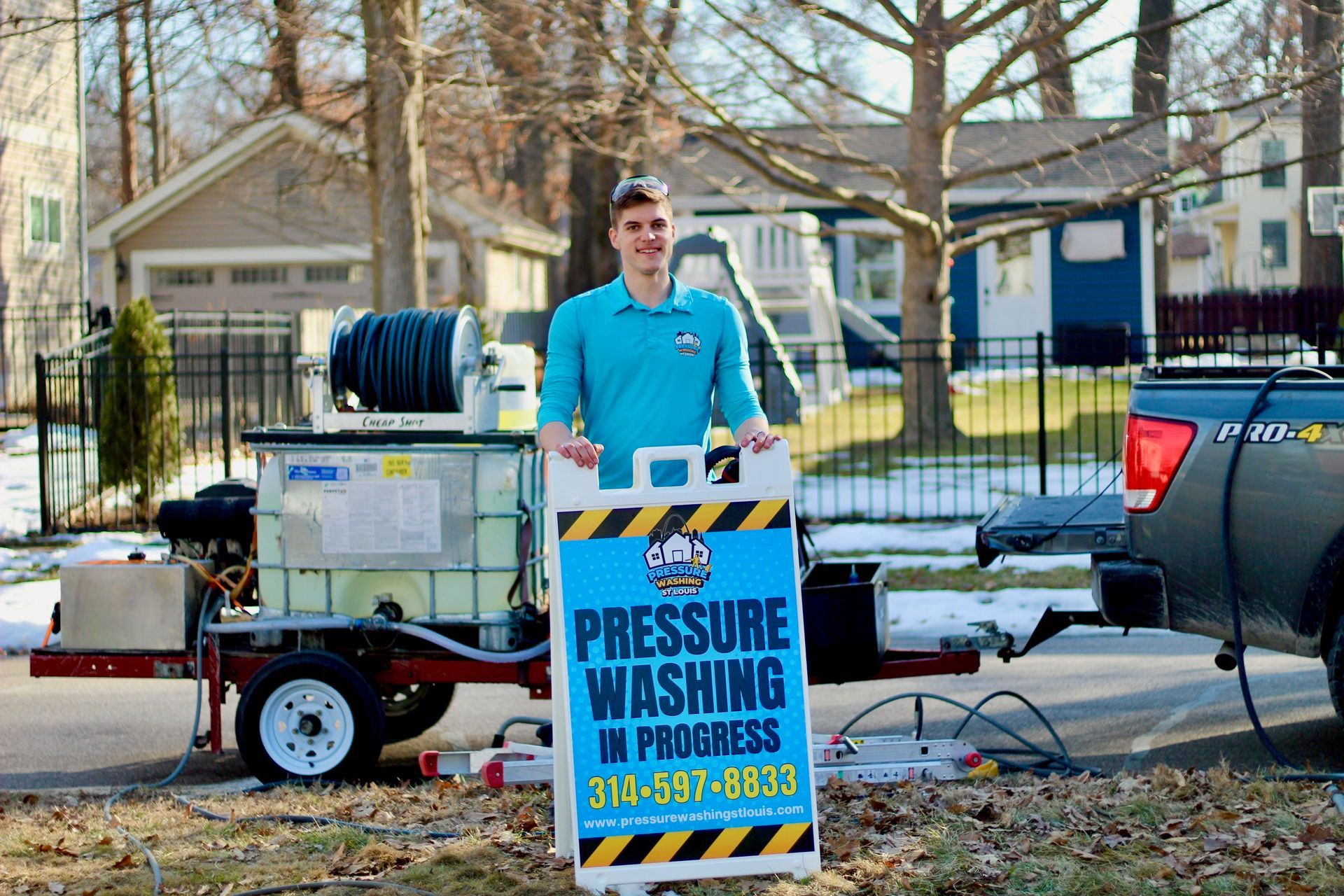 A person in a blue shirt poses behind a 