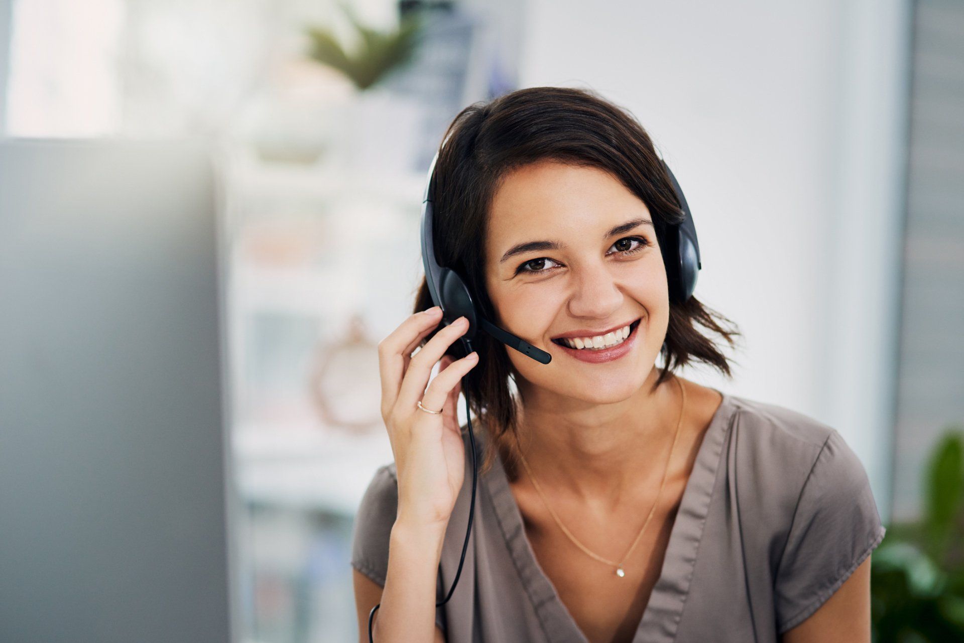 Woman in headset smiling | Dothan, AL | PWC Message Center