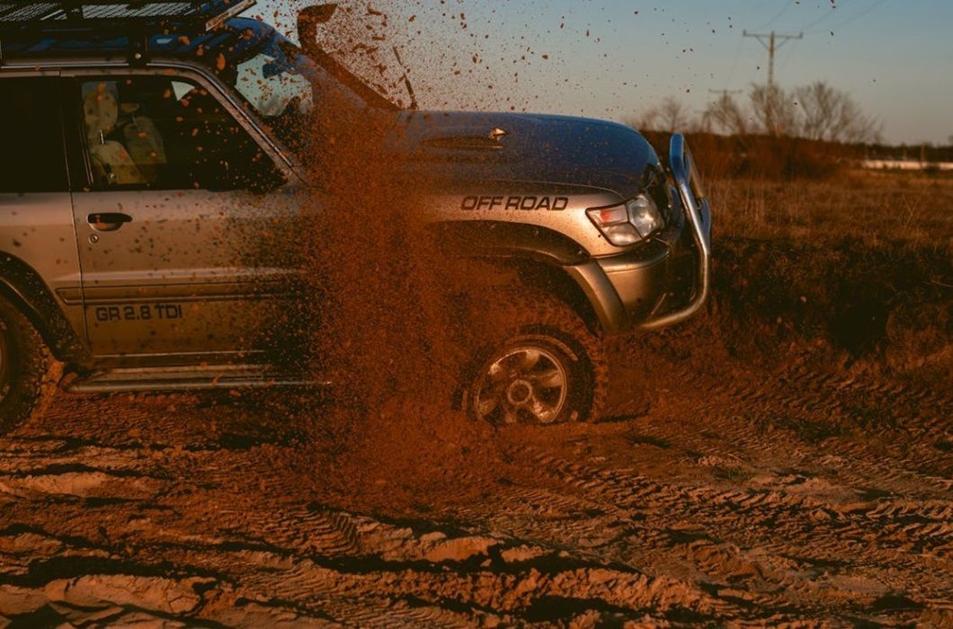 vehicle off roading in the mud